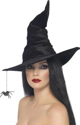 A woman wearing a witch hat with a spider hanging from it.