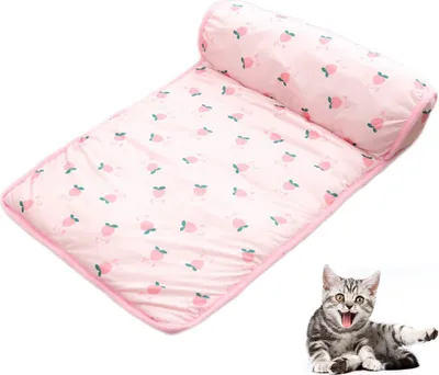 A pink pet cooling mat with a strawberry pattern and a small cat in the bottom right corner.