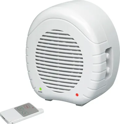 A white electronic device with a speaker grille and a remote control in front of it, set against a white background.