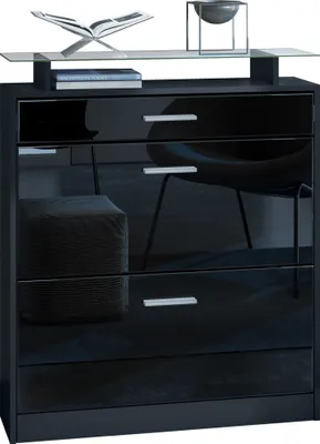 A black dresser with a glass shelf on top, displaying decorative items and books.