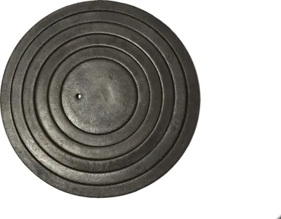 A circular, dark-colored object with concentric rings and a small hole in the center, presented against a white background.