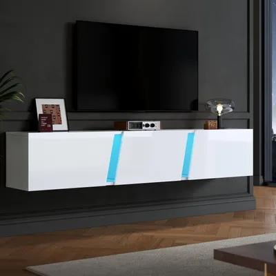A modern living room with a wall-mounted TV stand and a large television.