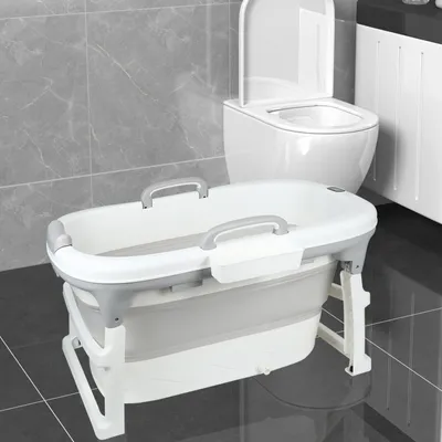A baby bathtub is shown in a bathroom setting next to a toilet and a cabinet.