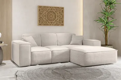 A modern living room with a beige sectional sofa and a large potted plant.