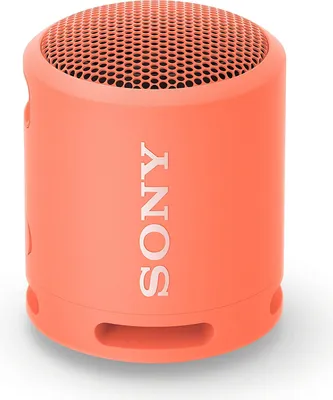 A coral pink Sony SRS-XB13 portable Bluetooth speaker is shown against a white background.