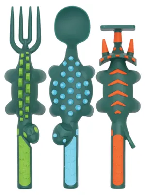 Three dinosaur-shaped children's utensils: a fork, a spoon, and a pusher.
