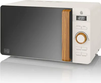 A white and gray microwave with a wood-effect handle and control knob, displayed on a reflective white surface.