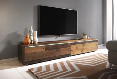 A modern living room with a TV stand and television.