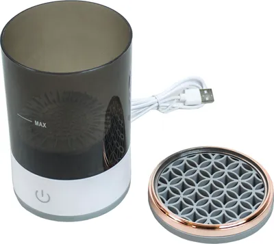A product shot of an electric USB brush cleaner and its lid.