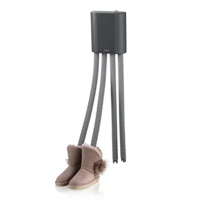 A shoe dryer with four flexible hoses is shown, with two beige boots attached to two of the hoses.