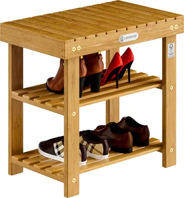 A wooden shoe rack with various shoes on its shelves.