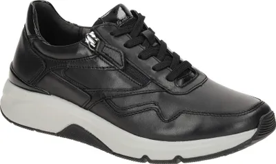 A black leather low-top sneaker with a white sole is shown against a white background.