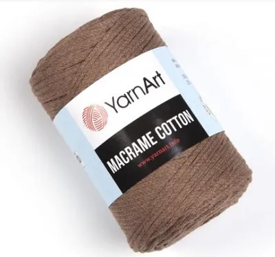 A roll of macrame cotton yarn on a white background.
