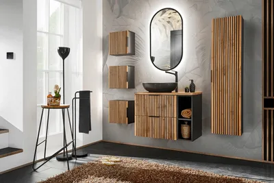 A modern bathroom vanity set with a sink, mirror, and storage cabinets, illuminated by ambient lighting.