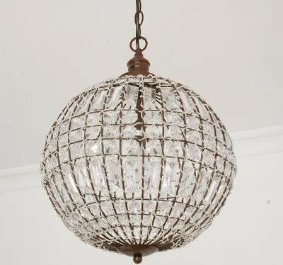 A spherical chandelier with crystal elements hanging from a chain.