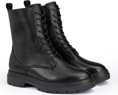 A pair of black lace-up boots shown from a diagonal angle against a white background.