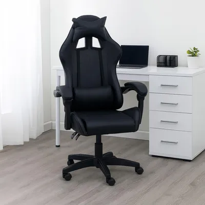 A black gaming chair is shown in a home office setting.