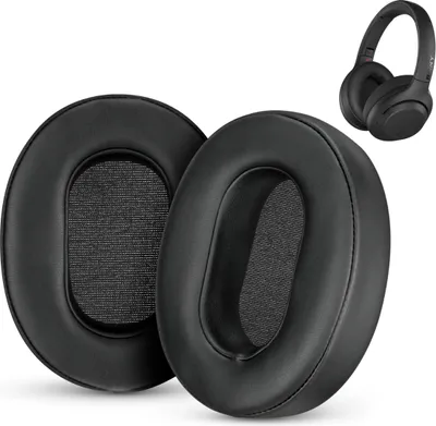 Two black ear pads for headphones are shown in the foreground, with a pair of black headphones in the background.