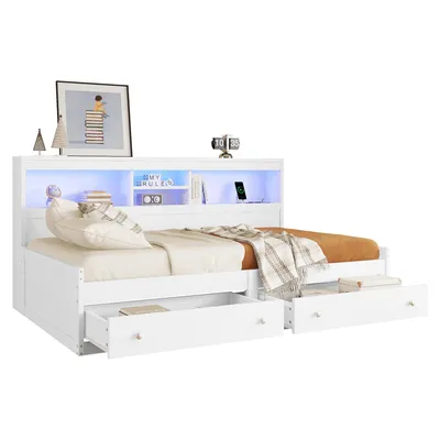 A white bed with drawers and a headboard with LED lighting.