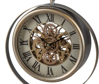 A close-up studio shot of a decorative antique-style desk clock with visible gears.