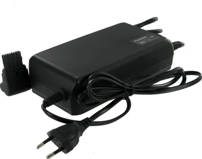A black E-bike charger with its cables and plug.