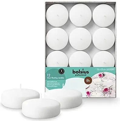 A box of white floating candles with three candles in the foreground.