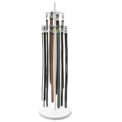 A floor-standing belt display rack with multiple belts hanging from it.