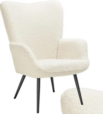 A fluffy cream armchair with black legs.