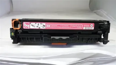 A toner cartridge is placed on a white surface.