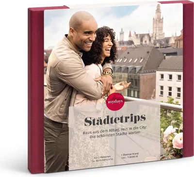 A couple embracing on a balcony overlooking a city skyline, with a gift box overlay.