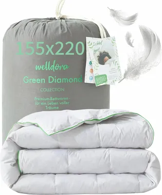 A folded duvet is shown in front of its packaging bag, with feathers floating around.