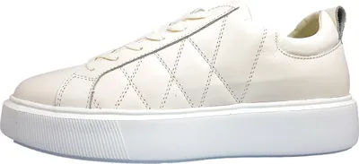 A side view of a white sneaker on a white background.