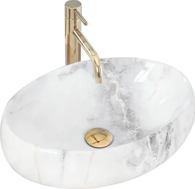 A white marble oval basin with a gold faucet and drain.