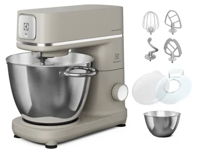A beige Electrolux kitchen mixer with its accessories displayed next to it on a white background.