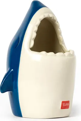 A ceramic pen holder shaped like a shark with its mouth open.