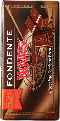 A close-up of a chocolate bar wrapper with a compass design and images of chocolate pieces.