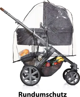 A stroller with a rain cover and items in the basket.