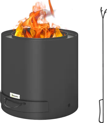 A black metal fire pit with flames and a fire poker next to it.