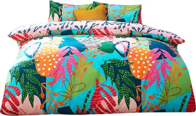 A colorful duvet cover and pillowcases with a tropical leaf and abstract pattern, laid out on a white background.