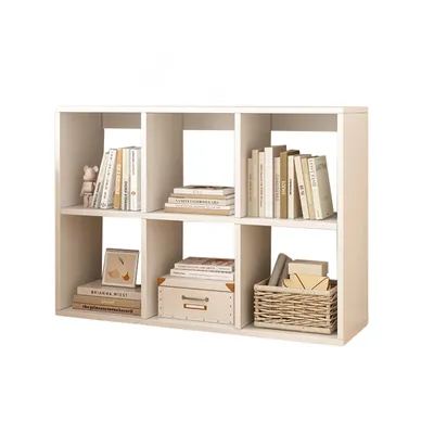 A white cube bookshelf filled with books and decorative items.