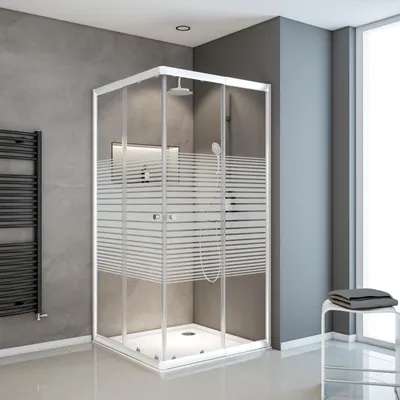 A modern bathroom with a corner shower cabin.