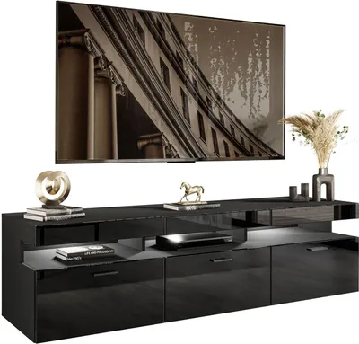 A modern black high-gloss TV lowboard with a large flat-screen TV mounted above it.