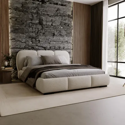 A modern bedroom with a large bed, textured stone wall, and wooden accents.