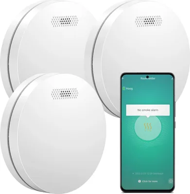 Three white smoke detectors are arranged with a smartphone displaying a smoke alarm app.