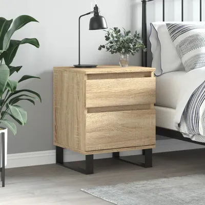 A bedside table with two drawers next to a bed.