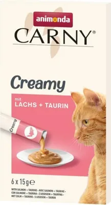 A box of Animonda Carny Creamy cat food with salmon and taurine, showing a cat and the product being poured onto a plate.