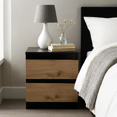 A bedside table next to a bed.