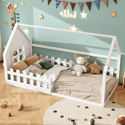 A child's bedroom with a white house-shaped bed decorated with stuffed animals and pillows.