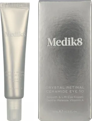 A silver tube of eye cream and its matching silver box are displayed side-by-side against a white background.