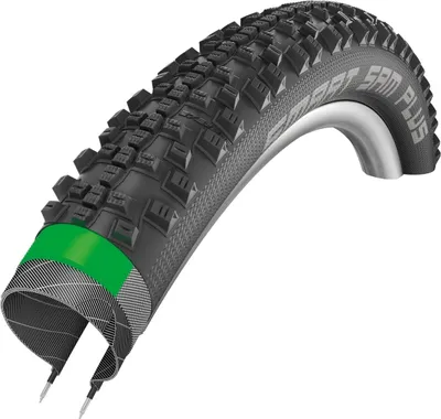 A close-up, studio shot of a bicycle tire, cut open to reveal its internal layers.